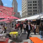 Mad. Sq. Eats, the outdoor pop-up food market, returned today for its annual spring residency across from Madison Square Park. From May 2nd through May 30th, 11 a.m. to 9 p.m. daily, it will form one prong (the other two being Shake Shack and Eataly) of the Madison Square Triangle Of Delicious. 30 vendors have food and drink on offer, from Mexican barbecue to Mediterranean soul food. Cheerful Marimekko prints cover the Bloomberg-standard metal tables and cafe chairs, and a convivial atmosphere reigns; strangers share tables and conversations alike at lunch hour and in the evenings. David Berliner, chair of the Madison Square Park Conservancy, which hosts the event, says he's "thrilled" to see "restauranteurs bring their delicious gifts to the neighborhood...you'll see a huge amount of diversity; people with kids, older people, people of every color and culture, that mix of cultures that's reflected in the food, which we curate carefully to reflect the diversity of NYC and of the world."To save you the time of shuffling through every vendor—crucial, given that if you want a seat on a nice day, showing up early and being decisive is essential—we've picked some of the yummiest treats on offer.     (Ben Miller/Gothamist) 